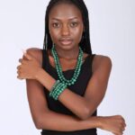 Two-layer malachite beaded necklace with four matching bracelets, showcasing deep green tones and natural banding.