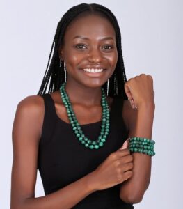 Two-layer malachite beaded necklace with four matching bracelets, showcasing deep green tones and natural banding.