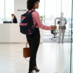 Indigo denim backpack with vibrant Ankara florals in pink, yellow, and sky blue—bold, structured, and perfect for everyday use or travel.