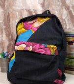 Indigo denim backpack with vibrant Ankara florals in pink, yellow, and sky blue—bold, structured, and perfect for everyday use or travel.