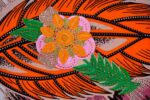 Desert Mirage Clutch featuring bold orange feather design and hand-beaded floral appliqué with sequins, inspired by the Vaal region.