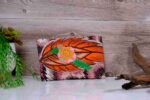 Desert Mirage Clutch featuring bold orange feather design and hand-beaded floral appliqué with sequins, inspired by the Vaal region.