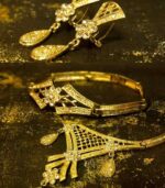 Gold-Plated Floral Set with crystal-tipped floral motifs, including necklace, earrings, and bracelet from L’Africaine Boutique.