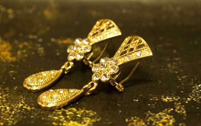 Gold-Plated Floral Set with crystal-tipped floral motifs, including necklace, earrings, and bracelet from L’Africaine Boutique.