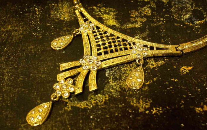 Gold-Plated Floral Set with crystal-tipped floral motifs, including necklace, earrings, and bracelet from L’Africaine Boutique.