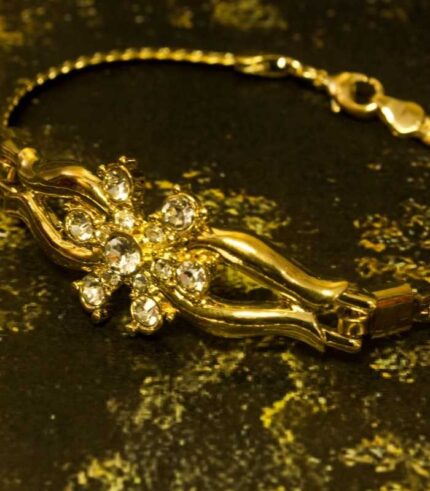 Golden Bloom Radiance Set with gold-plated floral motifs and crystal accents, including necklace, bracelet, and earrings from L’Africaine Boutique.