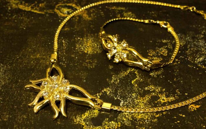 Golden Bloom Radiance Set with gold-plated floral motifs and crystal accents, including necklace, bracelet, and earrings from L’Africaine Boutique.