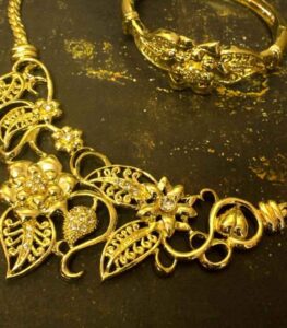 Growing Flower Necklace, Bracelet, and Earrings Set with sculpted gold-plated floral motifs and diamond-like crystal accents from L’Africaine Boutique.