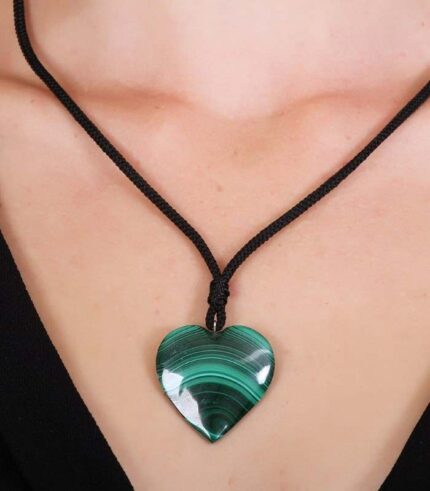 Heart-shaped green malachite pendant on a black cord, showcasing natural swirling patterns.