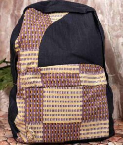 Indigo Heritage Backpack with deep indigo fabric and woven panels in gold, cream, and aubergine, featuring structured form and L’Africaine Boutique insignia.