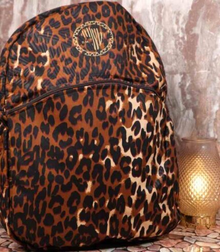Leopard Luxe Backpack with golden brown and black leopard print, sleek silhouette, front pocket, and L’Africaine Boutique emblem.