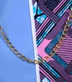 Lilac Sky African Cinch Bag with soft blue-lilac panel, geometric Ankara print in pink, teal, and purple, and gold chain drawstring.