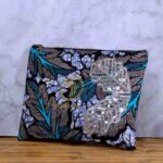 Ocean Rhythm African Clutch with bold black and white leaf print, blue and purple accents, and silver sequin leaf embellishments.