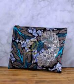 Ocean Rhythm African Clutch with bold black and white leaf print, blue and purple accents, and silver sequin leaf embellishments.