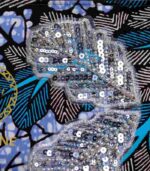 Ocean Rhythm African Clutch with bold black and white leaf print, blue and purple accents, and silver sequin leaf embellishments.
