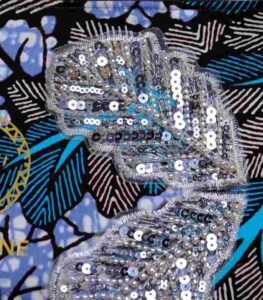 Ocean Rhythm African Clutch with bold black and white leaf print, blue and purple accents, and silver sequin leaf embellishments.