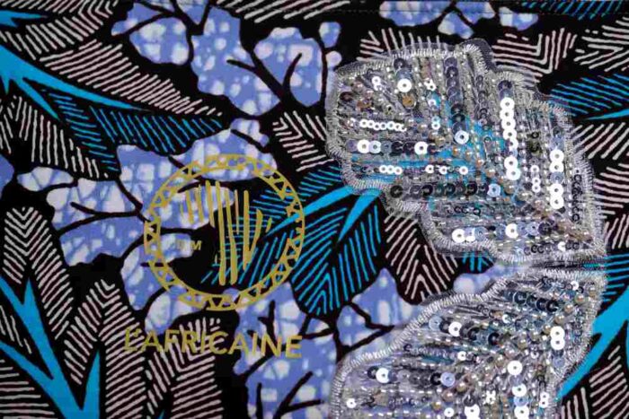 Ocean Rhythm African Clutch with bold black and white leaf print, blue and purple accents, and silver sequin leaf embellishments.