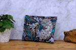 Ocean Rhythm African Clutch with bold black and white leaf print, blue and purple accents, and silver sequin leaf embellishments.