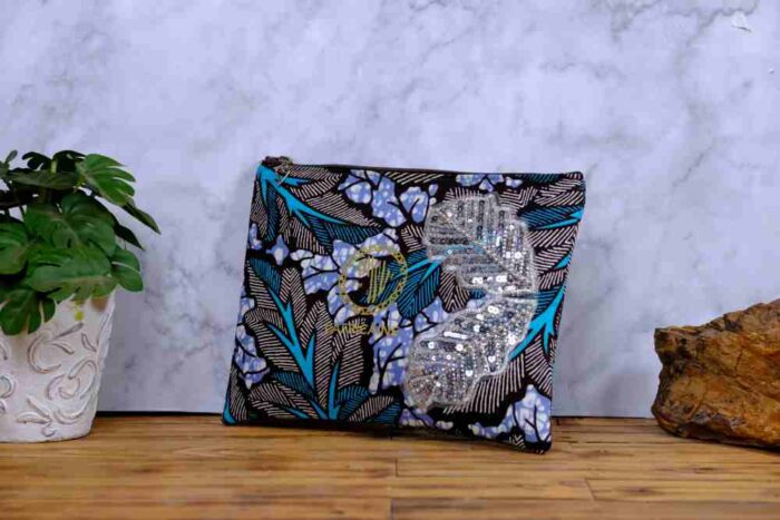 Ocean Rhythm African Clutch with bold black and white leaf print, blue and purple accents, and silver sequin leaf embellishments.