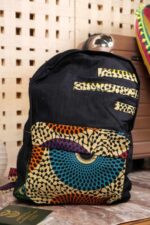Plume Ankara Backpack with elongated teardrop motifs in teal, golden yellow, and amber orange on ivory, featuring L’Africaine Boutique logo.