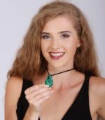 Teardrop-shaped green malachite pendant with natural banding on a black cord, symbolizing healing and emotional release.