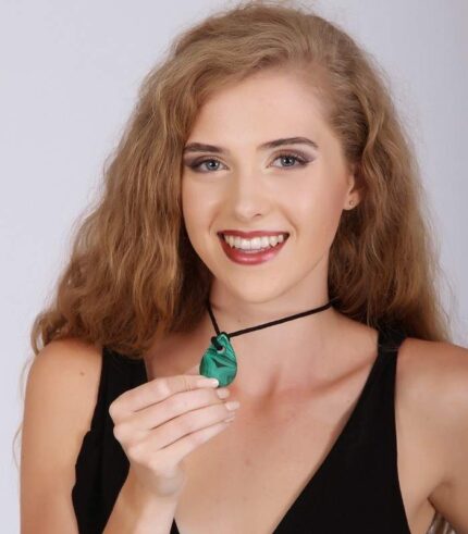 Teardrop-shaped green malachite pendant with natural banding on a black cord, symbolizing healing and emotional release.