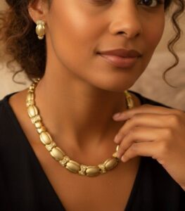 Timeless Golden Grace gold-plated necklace and bracelet set with fluid links and crystal accents, crafted by L’Africaine Boutique.