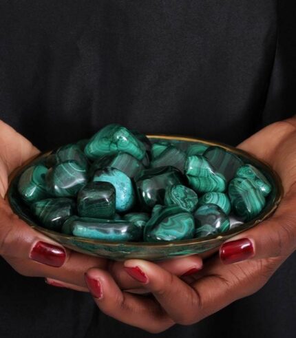 Decorative dish filled with 13 polished malachite stones of various sizes and shapes, showcasing rich green tones and natural banding.