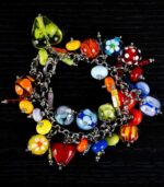 African Love bracelet with crimson, emerald, gold, and sapphire glass beads featuring dotted and rippled accents from L’Africaine Boutique.