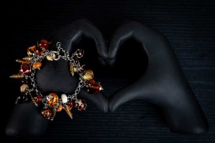 Animal Print bracelet with amber, cream, and brown glass beads featuring spotted and swirling patterns from L’Africaine Boutique.