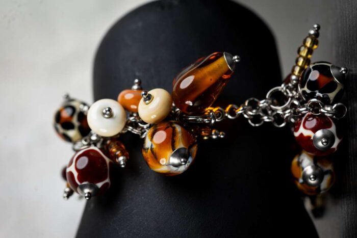 Animal Print bracelet with amber, cream, and brown glass beads featuring spotted and swirling patterns from L’Africaine Boutique.