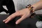 Animal Print bracelet with amber, cream, and brown glass beads featuring spotted and swirling patterns from L’Africaine Boutique.