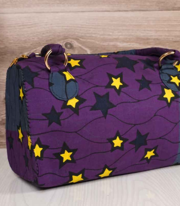 Ankara star print handbag ankara star print handbag in deep purple and navy Ankara wax fabric with bold yellow and black star patterns, gold rings, and top zipper closure.
