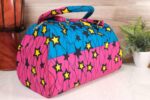 ankara star print purse by L’Africaine Boutique—crafted from wax fabric with bold star patterns, padded handles, and secure zipper closure.