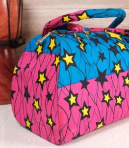 ankara star print purse by L’Africaine Boutique—crafted from wax fabric with bold star patterns, padded handles, and secure zipper closure.