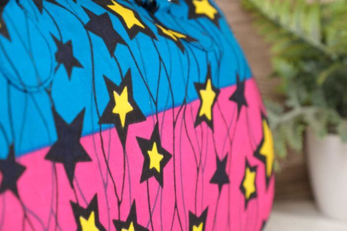 ankara star print purse by L’Africaine Boutique—crafted from wax fabric with bold star patterns, padded handles, and secure zipper closure.