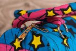 ankara star print purse by L’Africaine Boutique—crafted from wax fabric with bold star patterns, padded handles, and secure zipper closure.