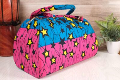 ankara star print purse by L’Africaine Boutique—crafted from wax fabric with bold star patterns, padded handles, and secure zipper closure.