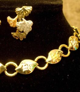 Artistic Gold-Plated Necklace and Earrings Set with engraved abstract motifs and two-tone floral accents from L’Africaine Boutique.