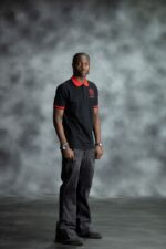 Black & Red Polo shirt with bold red collar and sleeve accents, featuring embroidered L’Africaine Boutique logo on the chest.