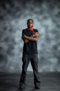 Black & Red Polo shirt with bold red collar and sleeve accents, featuring embroidered L’Africaine Boutique logo on the chest.