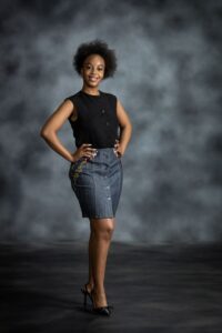 Contrast Denim Skirt in medium-wash denim with yellow-and-blue Ankara inserts and button-down front from L’Africaine Boutique.