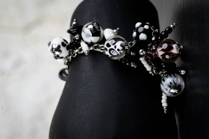 Dalmatians bracelet with black and white glass beads featuring marbled swirls and spotted motifs from L’Africaine Boutique.