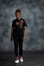 Double Bloom Tee with twin Ankara floral appliqués and gold emblem from L’Africaine Boutique.