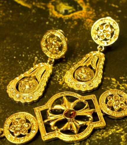 Elegant Teardrop Necklace and Earrings Set with gold-plated engravings and red gem accents from L’Africaine Boutique.