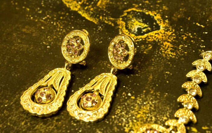Elegant Teardrop Necklace and Earrings Set with gold-plated engravings and red gem accents from L’Africaine Boutique.