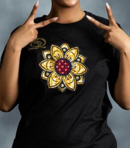 Floral Burst Tee with mandala-style flower appliqué in yellow, white, and red, accented by rhinestones on black cotton from L’Africaine Boutique.
