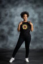 Floral Burst Tee with mandala-style flower appliqué in yellow, white, and red, accented by rhinestones on black cotton from L’Africaine Boutique.