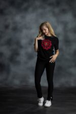 Floral Medallion Tee with layered red and navy floral print, rhinestones, and gold accents on black cotton from L’Africaine Boutique.