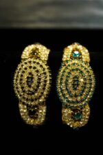 Gold-Plated Oval Bangles with concentric crystal patterns in black, aqua, and ruby tones from L’Africaine Boutique.